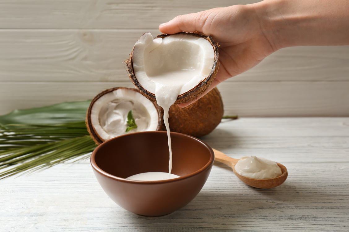 Woman Pouring Coconut Cream into Bowl